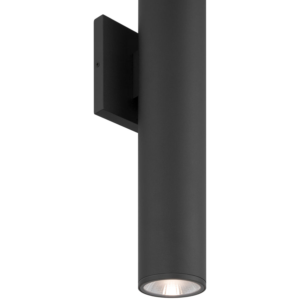 A modern black cylindrical wall-mounted outdoor light fixture, the Sunset Bi-Directional Outdoor LED Wall Washer (19977LEDMG) by Access Lighting, features an energy-efficient LED bulb.