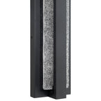 Close-up of the Access Lighting Riviera LED Outdoor Wall Mount, 24W—a modern rectangular black metal fixture featuring a vertically running, textured granite-like accent.