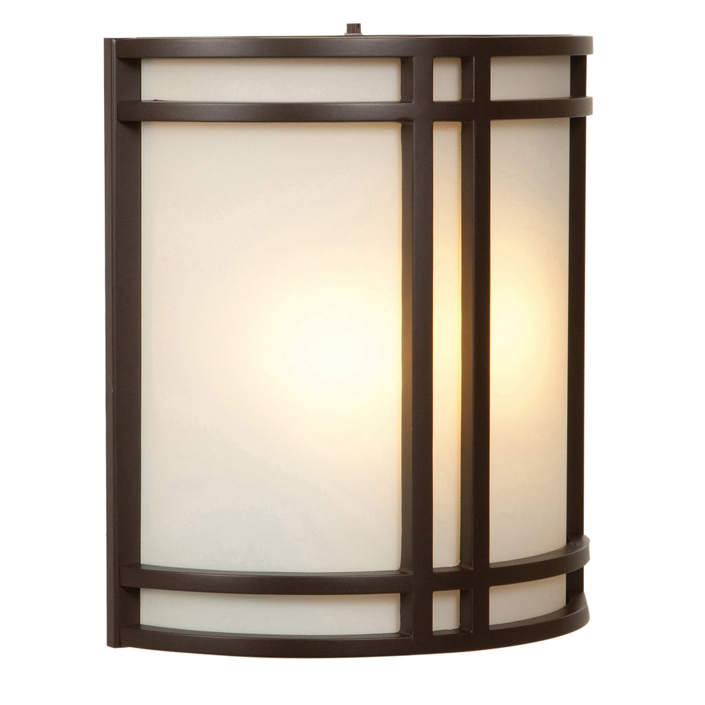 The Artemis 2 Light Outdoor LED Wall Mount by Access Lighting features a frosted glass shade encased in a dark bronze geometric frame, beautifully illuminated from within.