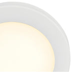 Close-up of the Access Lighting Slim LED Flush Mount, White / 7″, partially shown on the ceiling and emitting a warm yellowish glow.