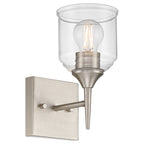 The Beacon 1 Light Wall Sconce by Access Lighting features a brushed steel base, a clear glass shade, and an exposed bulb.