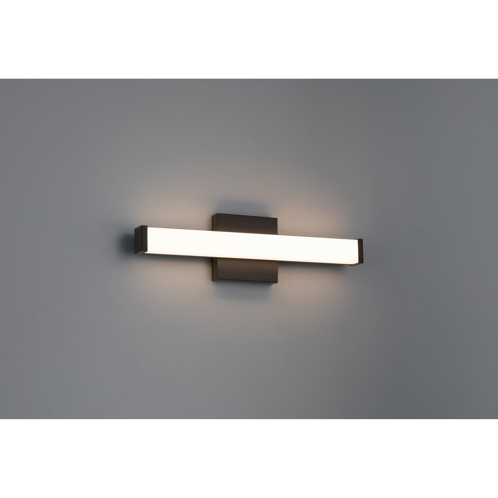 The Maxx 5CCT LED Vanity by Access Lighting is a modern, rectangular 18″ wall-mounted light fixture featuring a matte black base and a frosted horizontal shade, shown illuminated against a plain gray wall.