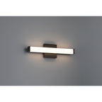 The Maxx 5CCT LED Vanity by Access Lighting is a modern, rectangular 18″ wall-mounted light fixture featuring a matte black base and a frosted horizontal shade, shown illuminated against a plain gray wall.