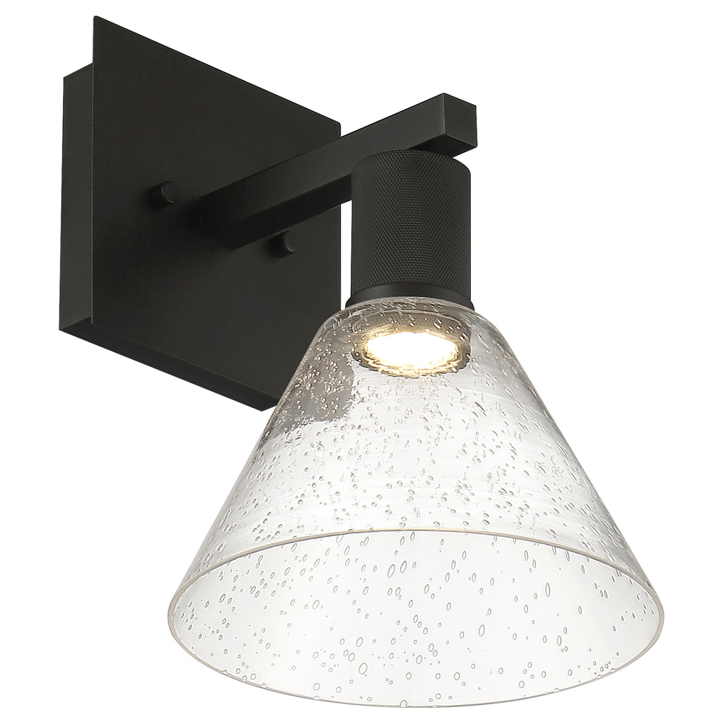The Access Lighting Port Nine Martini LED Wall Sconce features a matte black wall-mounted design with a wide, clear seeded glass cone-shaped shade and a downward-facing 9W LED bulb.