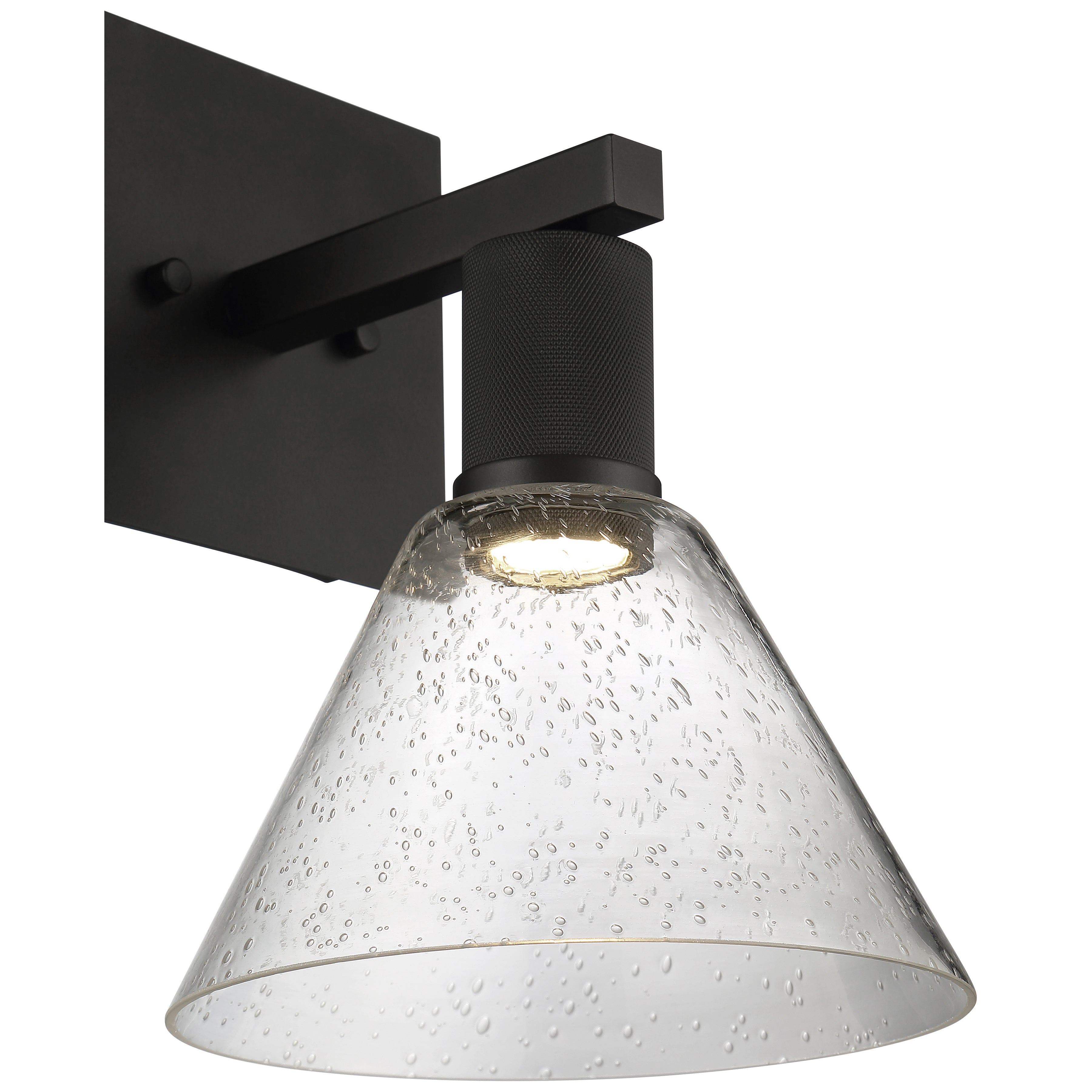 The Port Nine Martini LED Wall Sconce by Access Lighting features a matte black metal base and a clear, cone-shaped seeded glass shade with bubble details.