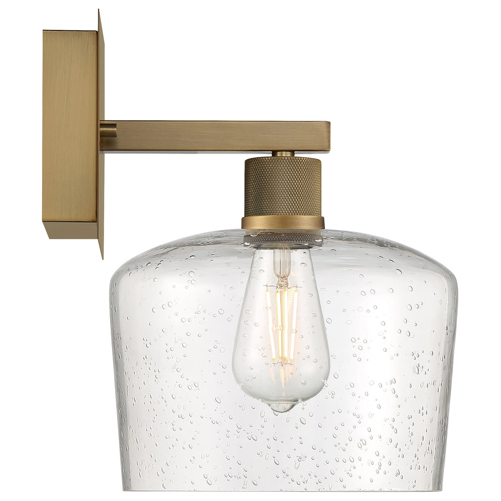 The Port Nine Chardonnay LED Wall Sconce by Access Lighting features an antique brushed brass finish and a seeded glass shade, with a 7W vintage-style bulb.