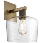 The Port Nine Chardonnay LED Wall Sconce by Access Lighting features an antique brushed brass finish, a seeded glass shade, and a 7W exposed vintage-style bulb, all mounted on a square backplate.