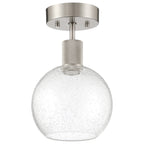 The Port Nine Burgundy LED Semi-Flush by Access Lighting is a modern ceiling light fixture featuring a brushed steel base and a seeded glass globe shade with bubble-like texture.