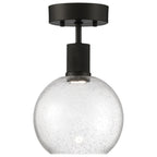 The Port Nine Burgundy LED Semi-Flush by Access Lighting features a round seeded glass shade with bubble details and a matte black metal fixture, offering a modern touch with its 9W LED design.