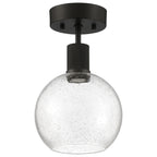 The Access Lighting Port Nine Burgundy LED Semi-Flush features a round, seeded glass shade and a matte black metal base and stem, utilizing a 9W LED.