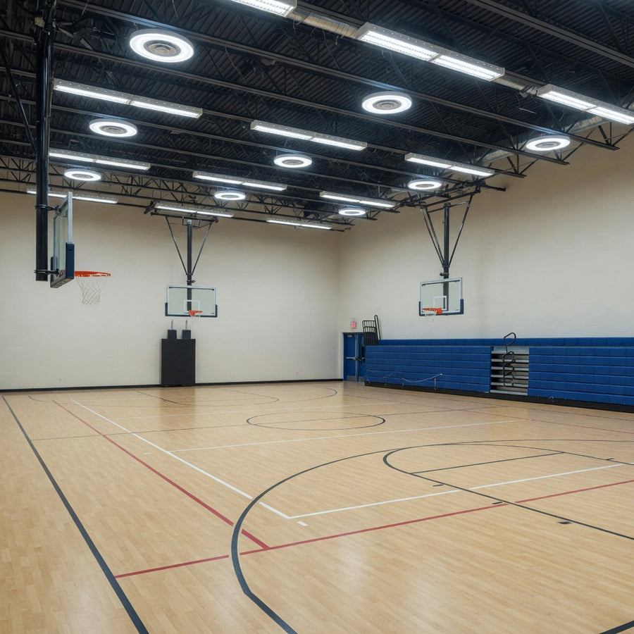 High school gym lit by round and linear LED high bays